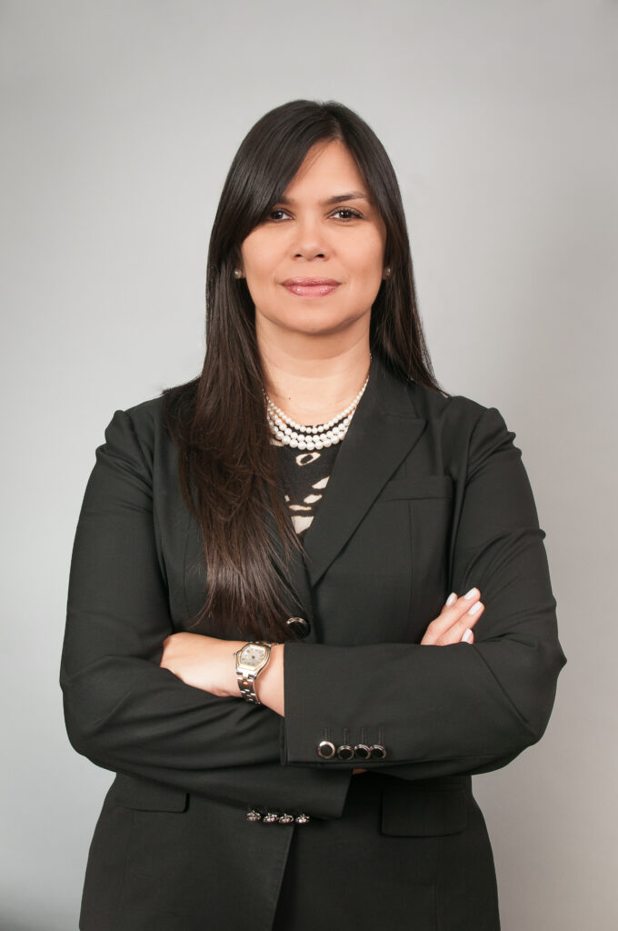 Immigration attorney Nera Shefer with arms crossed, dressed in black, known for her pivotal role in the creation of the DACA program.